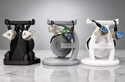 Black, gray and white IEM stands displaying WAVS in-ear monitors